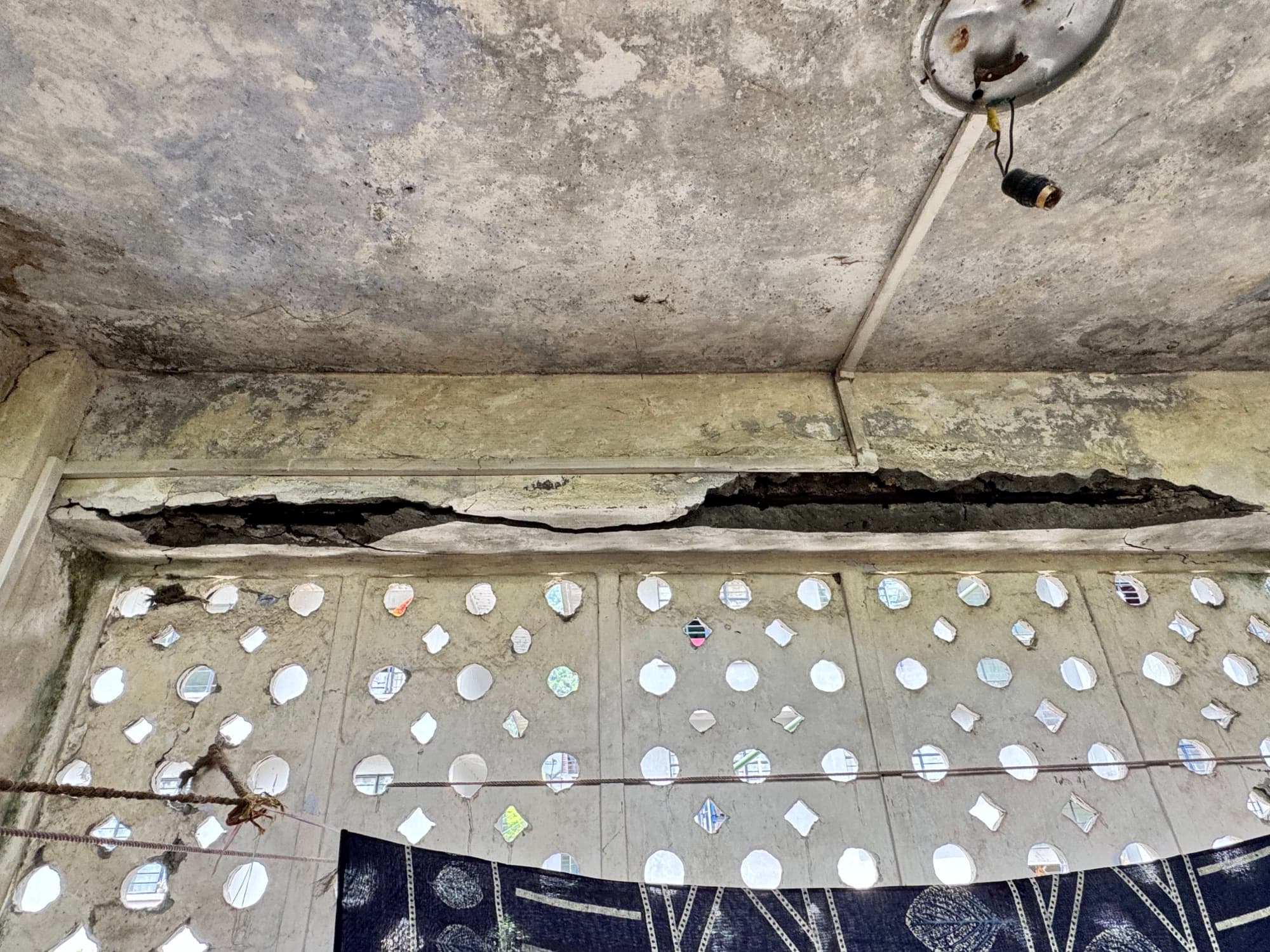 Spalled lintel beam above a perforated screen wall · Sikkim